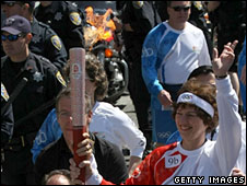 A torchbearer carries the Olympic flame in San Francisco